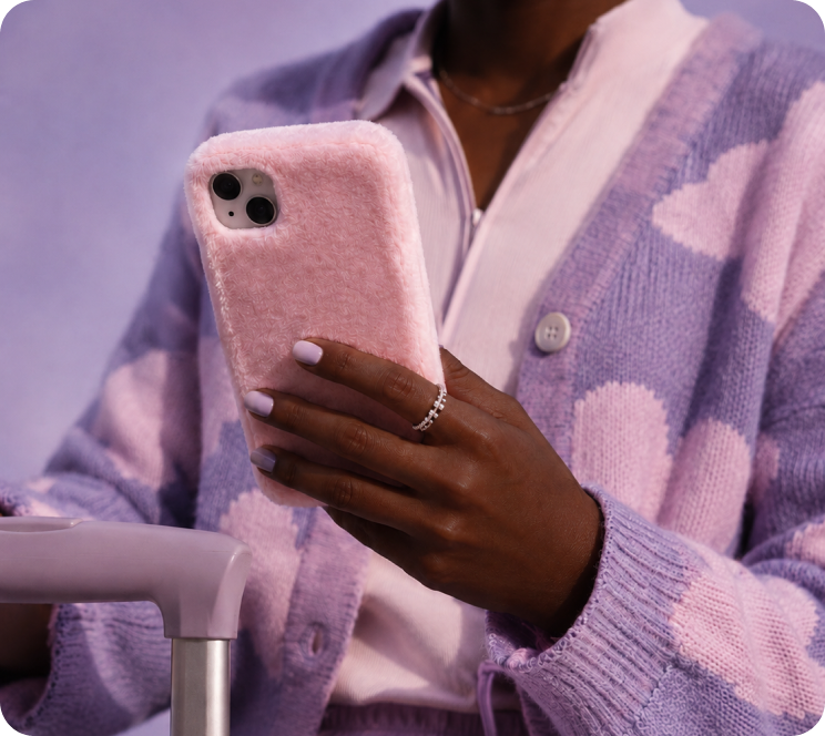Person holding a phone in a fluffy pink case